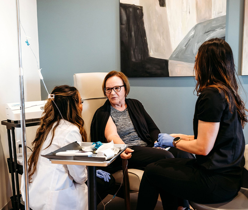 Lexi Yoo providing IV Therapy for a patient at Yoo Direct Health.