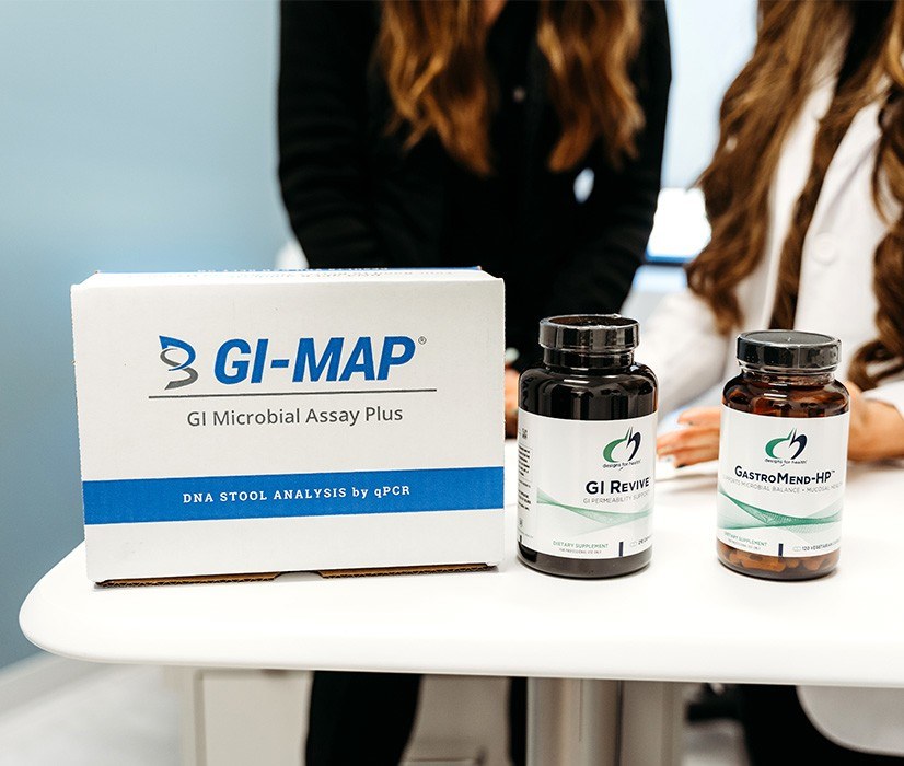 table with GI map test and supplement bottles