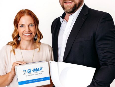 Nikki Keserich, NP and Allen Stewart, NP holding a GI-MAP stool analysis test kit at Yoo Direct Health