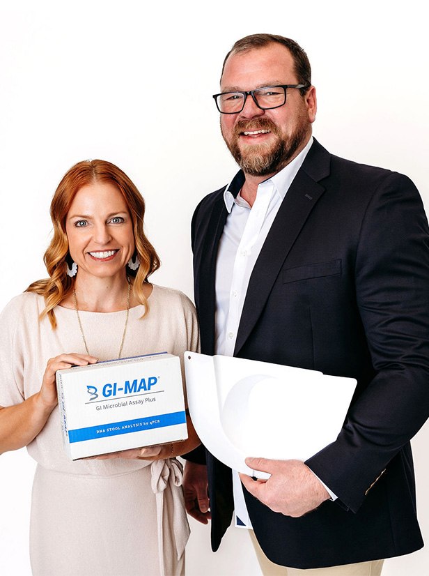 Nikki Keserich, NP and Allen Stewart, NP holding a GI-MAP stool analysis test kit at Yoo Direct Health