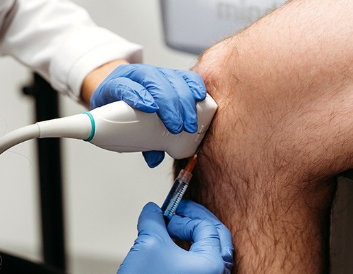 Provider using ultrasound to place injection in patient